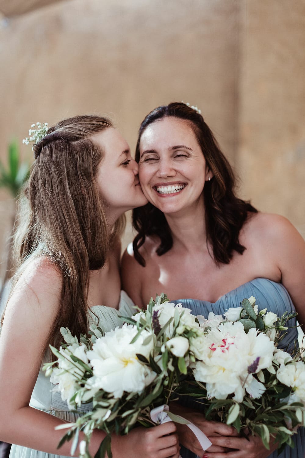 photo of daughter kissing smiling mother by photographer ibiza