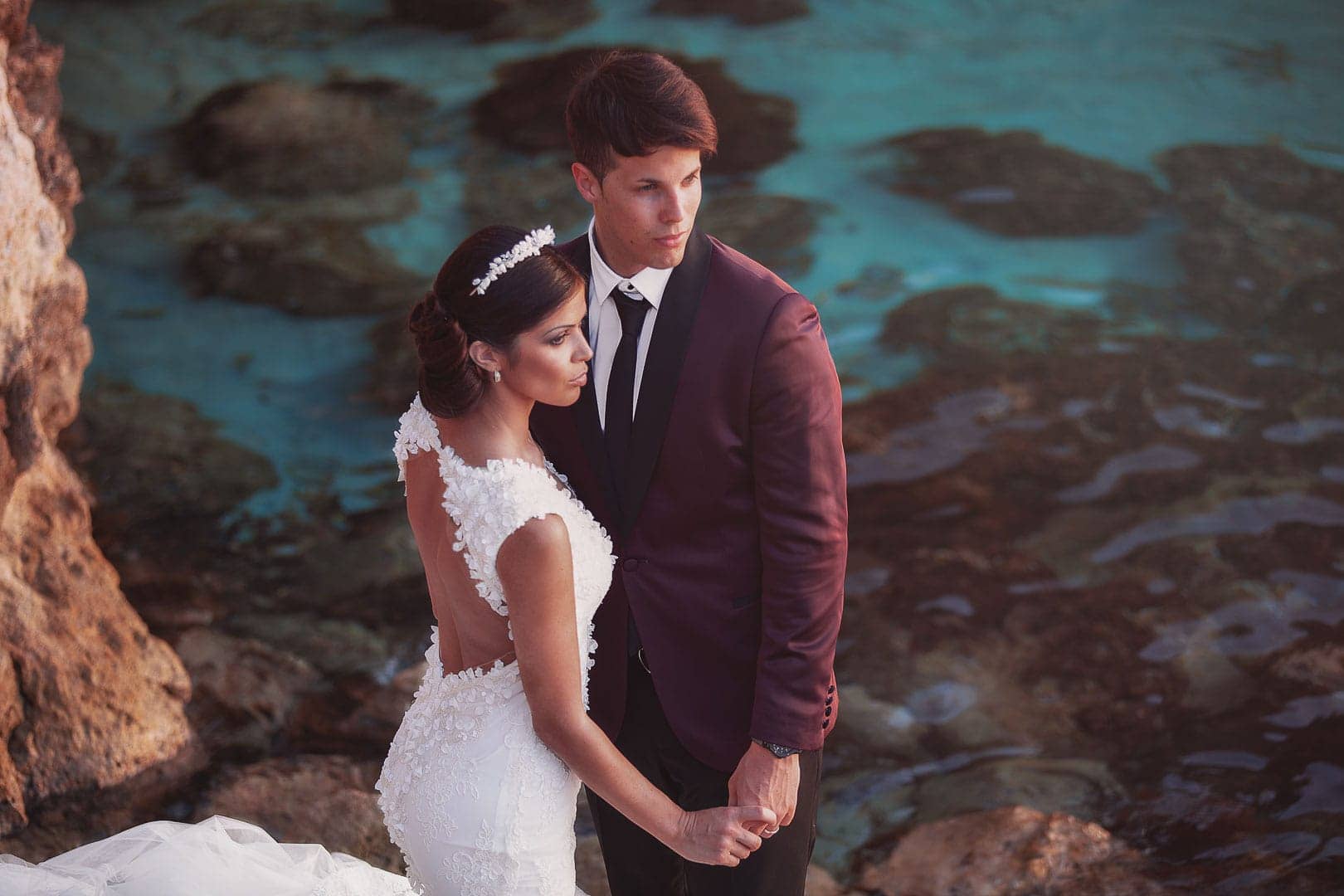 outdoor post wedding portrait of newlyweds posing in cala comte in Ibiza wedding photographer