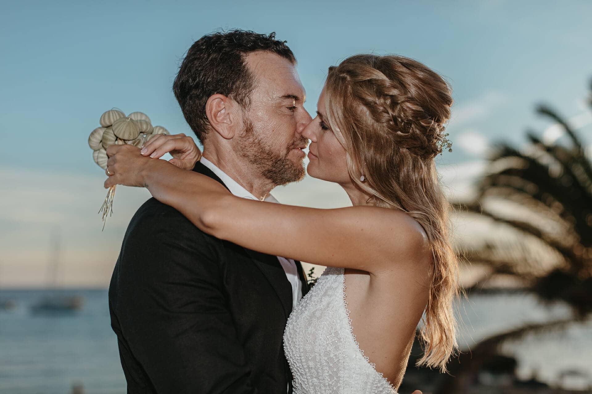 image of bride and groom kissing at sunset